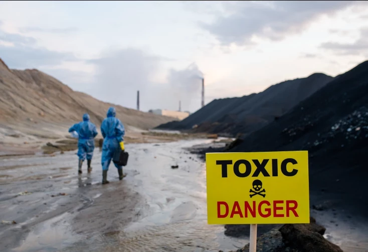 workers walking through toxic land