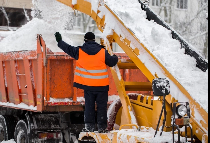 worker in heavy snow