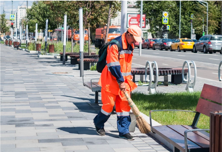 worker sweeping streets
