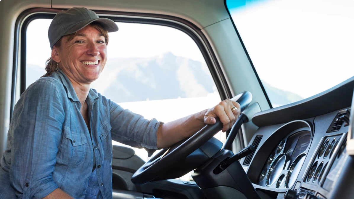 caucasian-woman truck driver in the cab of her 